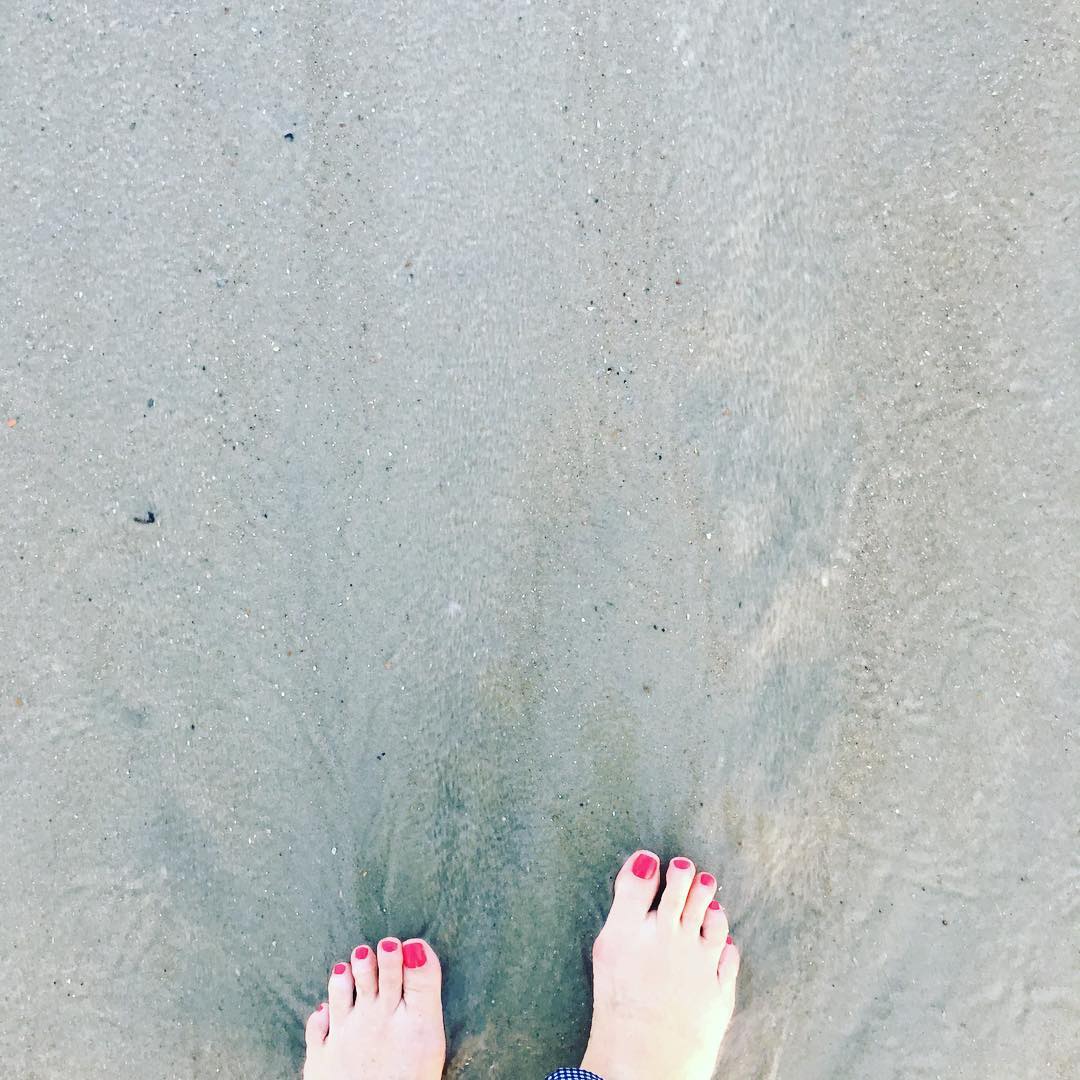 Toes in the sand, rosé in hand